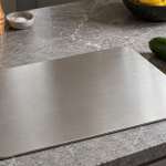 Plain metal cutting board on a kitchen counter