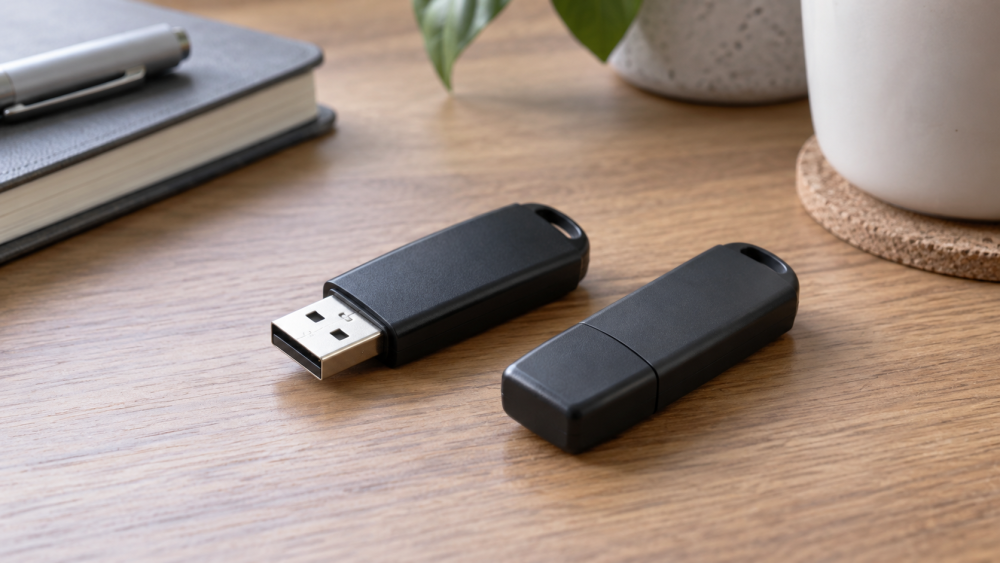 Two USB flash drives on a wooden desk